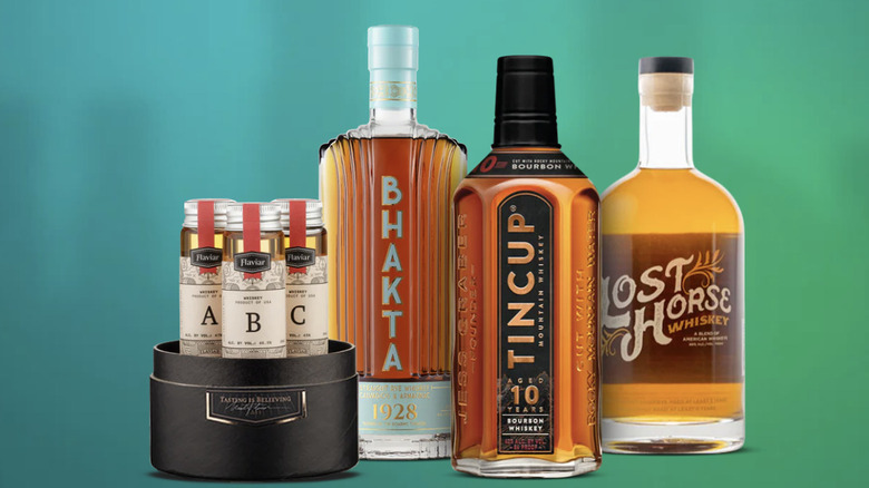 Three bottles of spirits from the American Road Trip whiskey tasting gift set on a green background