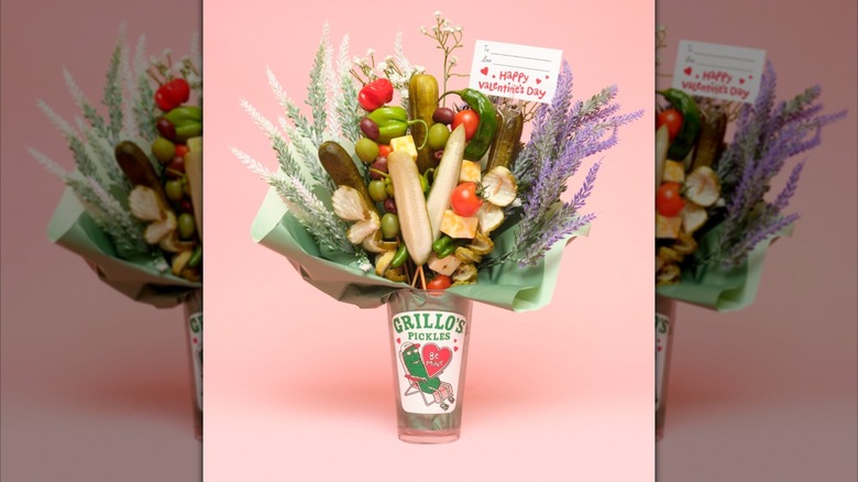 Grillo's Pickle Bouquet with vegetables and flowers on a pink background with a Valentine's Day card