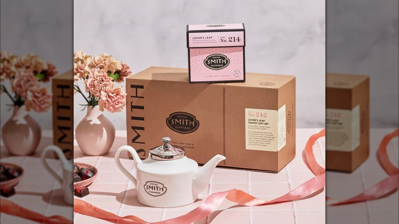 Box of Lover's Leap Teapot Gift Set behind tea pot and next to vase of flowers