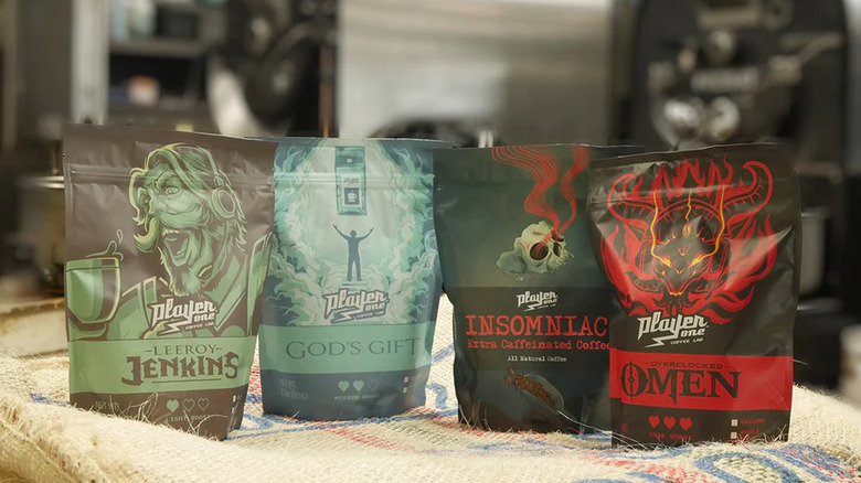 Four bags of Player One Coffee from the Ultimate Player One Coffee Sampler Pack sitting on cloth