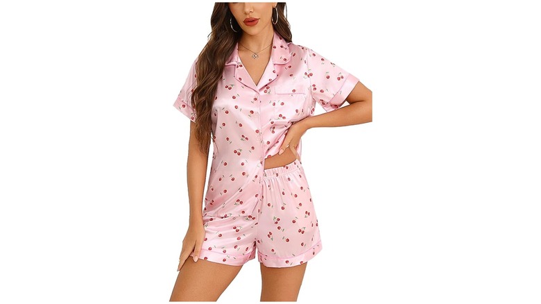 A person wearing pink cherry silk pajamas