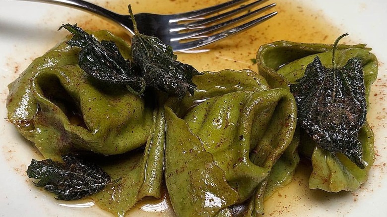 Nettle tortelloni on a plate with a fork