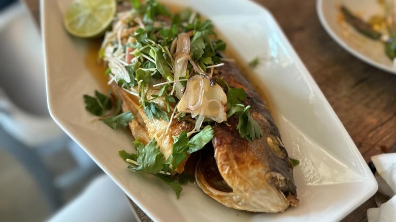 Whole fish dish with garnishes