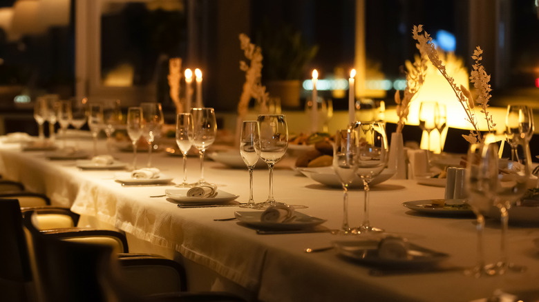 A set table with glassware and candles