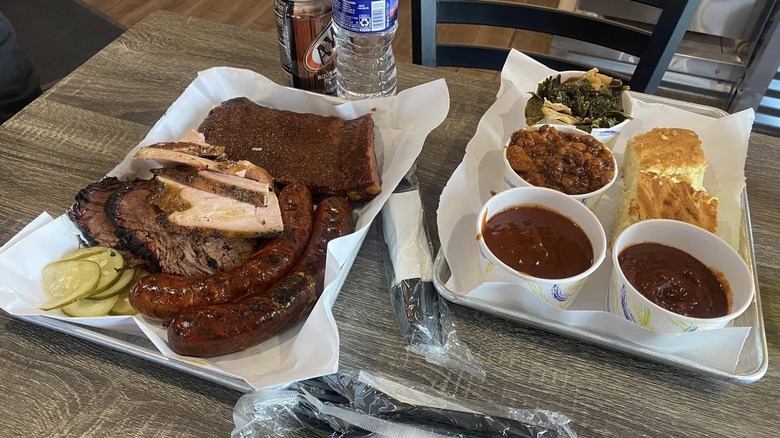 BBQ platters with brisket, ribs, sausages, and sides