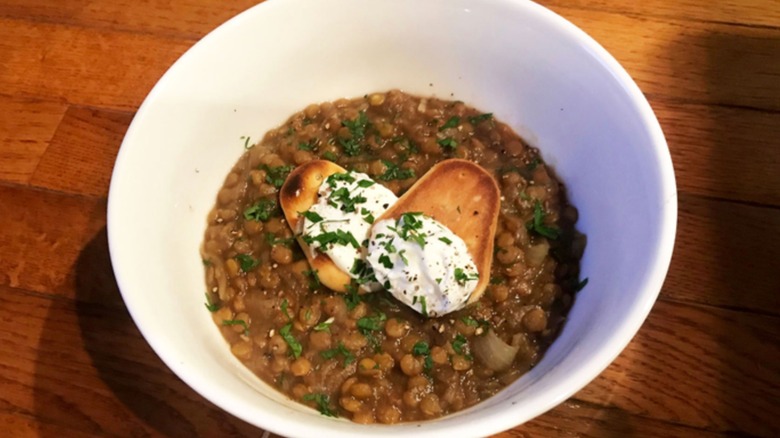 White bowl of French onion lentil soup