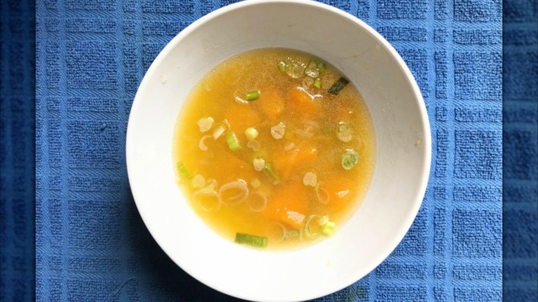 Bowl of kabocha squash soup on blue towel