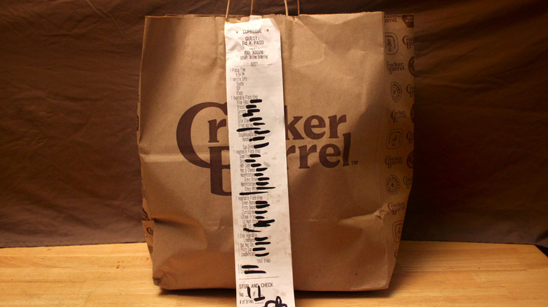 A takeout bag from Cracker Barrel containing a selection of 26 sides from the restaurant's dinner menu
