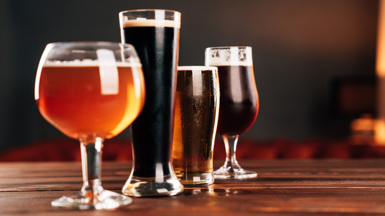 Several dark ales in a variety of beer glasses