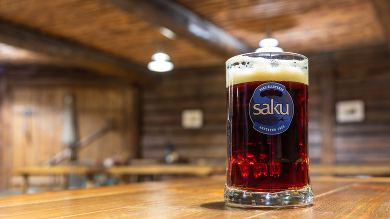 A mug of dark lager on a bar