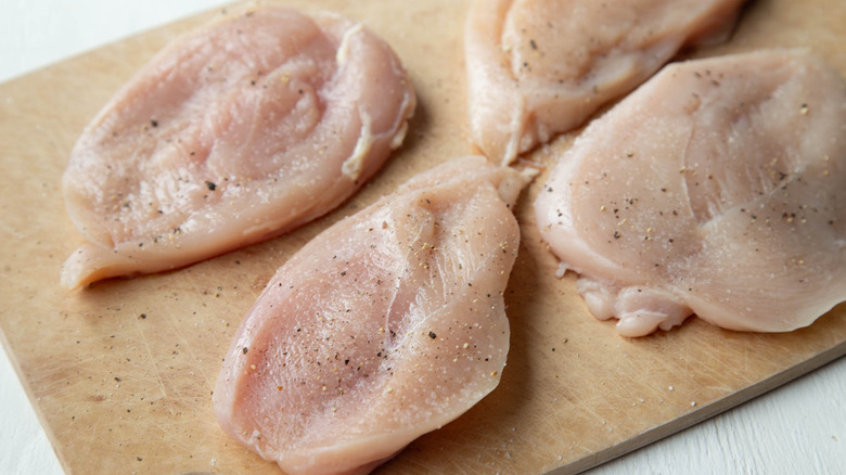 raw chicken breasts with salt and pepper