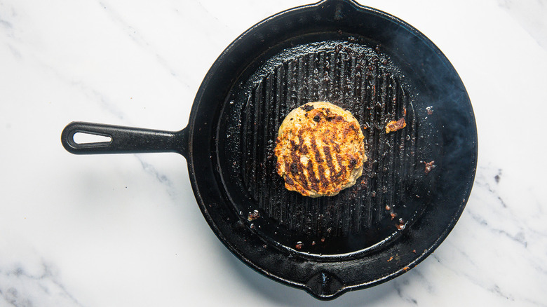 Cooked turkey burger in a cast iron grill pan.