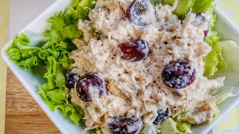 chicken salad with red grapes on a lettuce leaf
