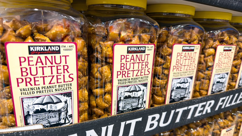 Containers of Kirkland peanut butter pretzels in a cardboard box