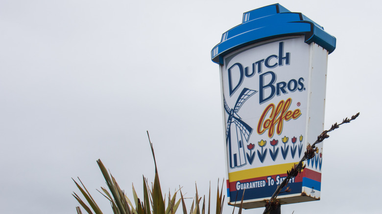 Sign for a Dutch Bros Coffee location, shaped like a takeout coffee cup