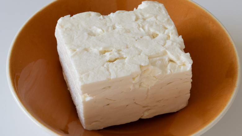 Block of feta cheese in a bowl