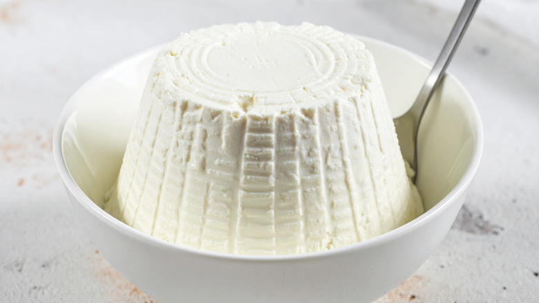 White dish of ricotta with spoon