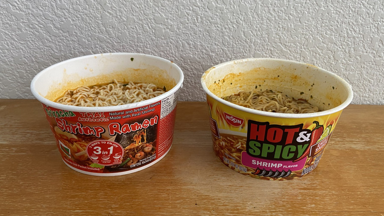 Thai Authentic Ramen and Nissin Ramen in their respective paper bowls