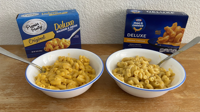Bowls of Premier Pantry mac and Kraft mac in front of their boxes