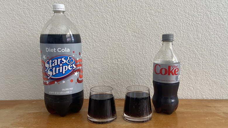 Glasses of Stars and Stripes cola and Diet Coke beside their bottles