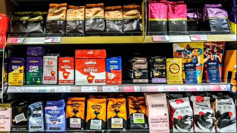 Various ground coffee bags on store shelf