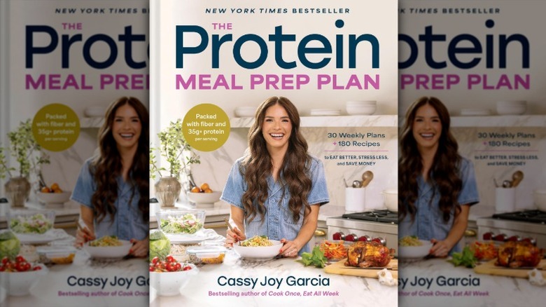 hardcover copy of a book entitled "The Protein Meal Prep Plan: 30 Weekly Plans + 180 Recipes to Eat Better, Stress Less, and Save Money"