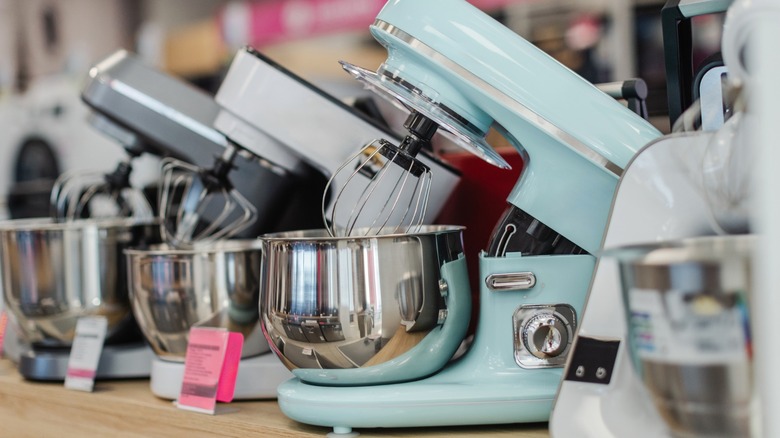 Multiple stand mixers on a store shelf