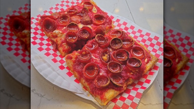 Two slices of Mimi's pepperoni square pizzas.