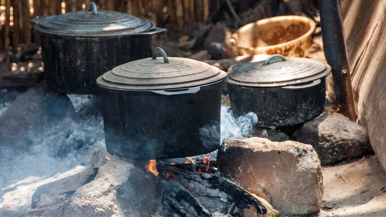 Cast iron pots over a campfire