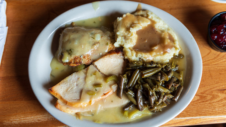 A turkey dinner at Cracker Barrel with green beans, mashed potatoes, and gravy.
