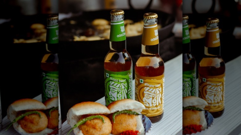 Coolberg non-alcoholic beers sitting on a table in front of food.