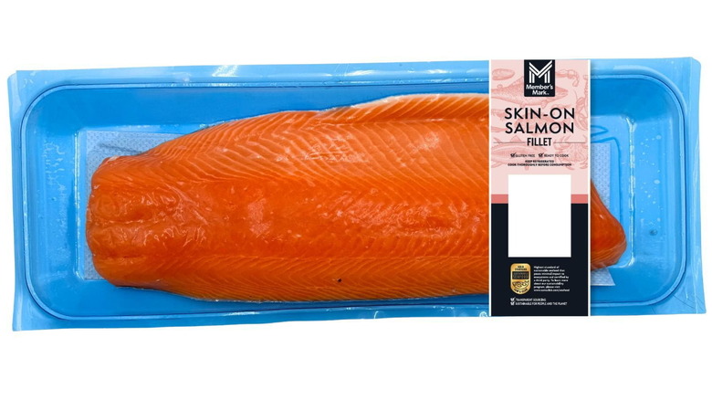 A package of bright pink, filleted salmon from Member's Mark in a blue plastic box on a white background.