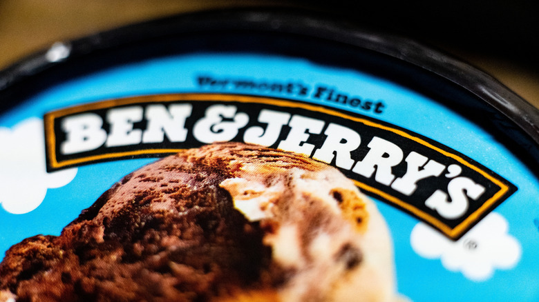 A close-up of the Ben & Jerry's Logo on the top of a pint of Ben & Jerry's ice cream.