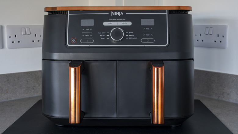 Ninja-branded black air fryer on a kitchen counter