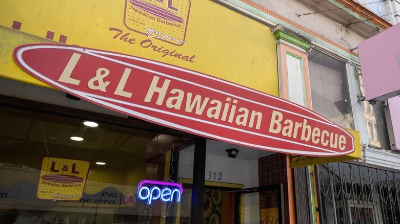 L&L Hawaiian Barbecue storefront with a neon open sign lit up.