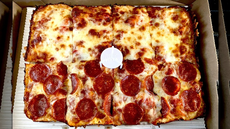A half-cheese, half-pepperoni Detroit-style pizza from Jet's Pizza in its cardboard box