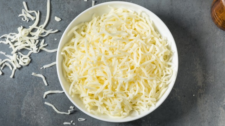 Shredded mozzarella in a bowl.