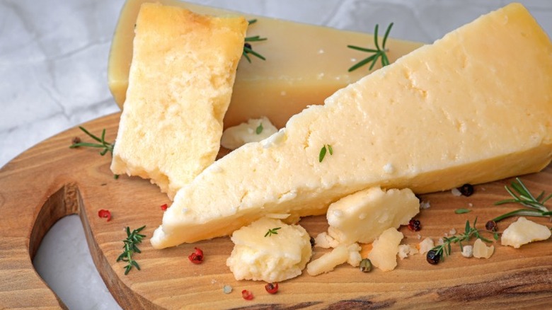 Parmigiano Reggiano on a wooden cutting board.