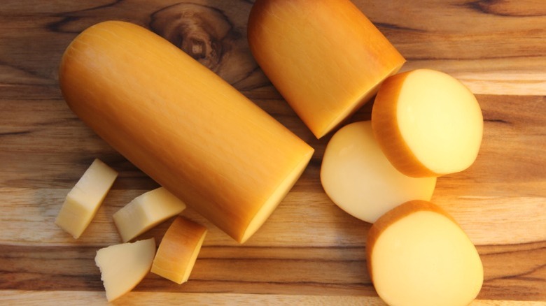 Provolone slices on a wooden board.