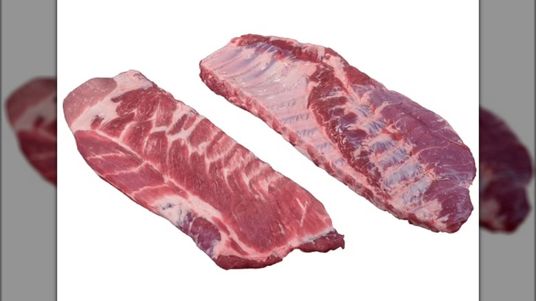 Two raw slabs of spare ribs on a white background