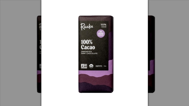 Raaka 100% Cacao unroasted dark chocolate bar on a white background.