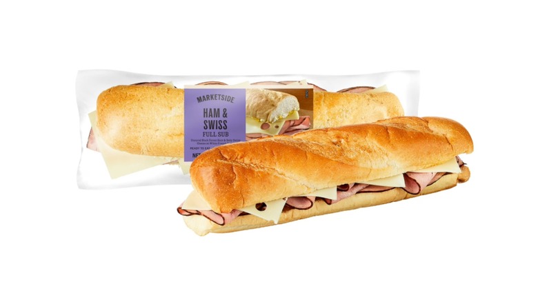 Two Marketside Ham and Swiss Full Subs, one wrapped in clear plastic and the other unwrapped, on a white background