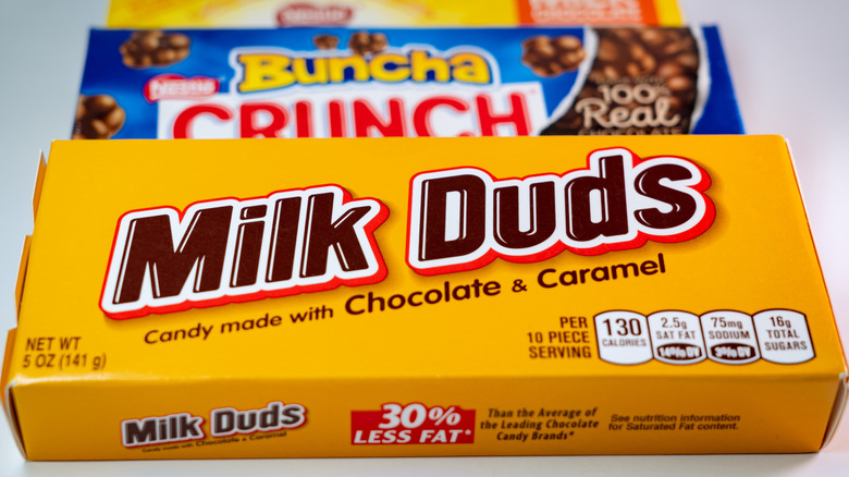 Box of Milk Duds and box of Buncha Crunch in the background.