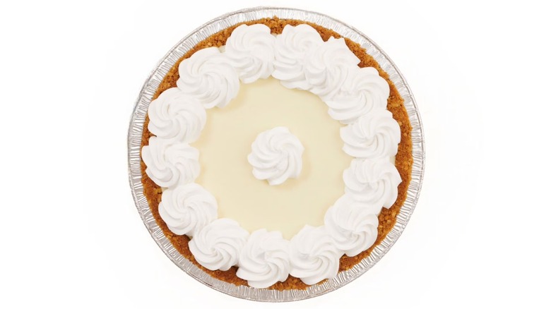 A large Key lime pie decorated with whipped topping shot from above