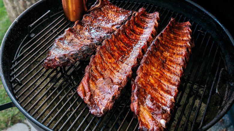Three racks of pork ribs on the grill