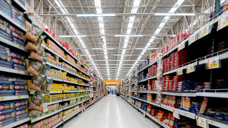 A supermarket with clean floors and fully stocked shelves.