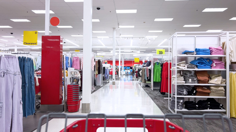The front part of a Target shopping cart is visible in the clothing section