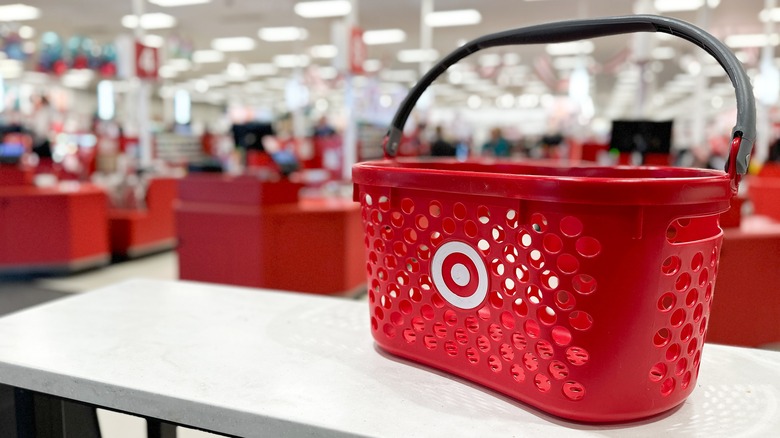 A Target shopping basket sits on a table inside the store