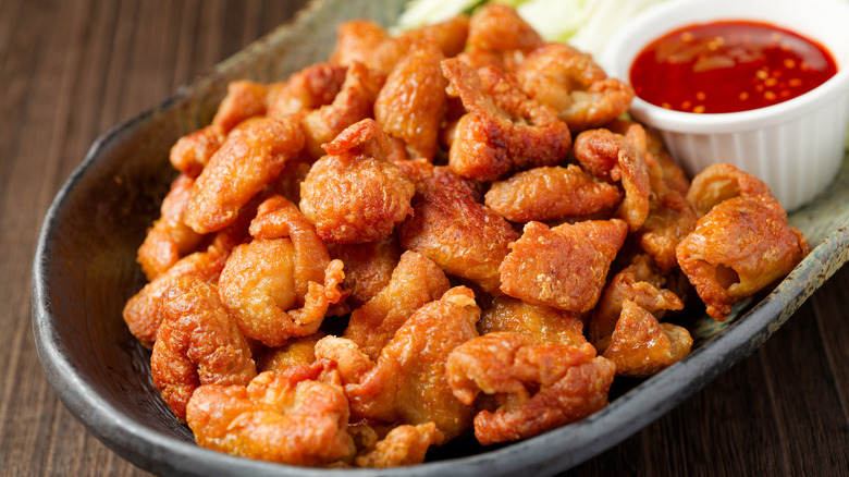 gribenes with a red dipping sauce