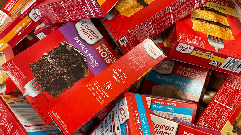 Pile of assorted boxes of Duncan Hines cake mix